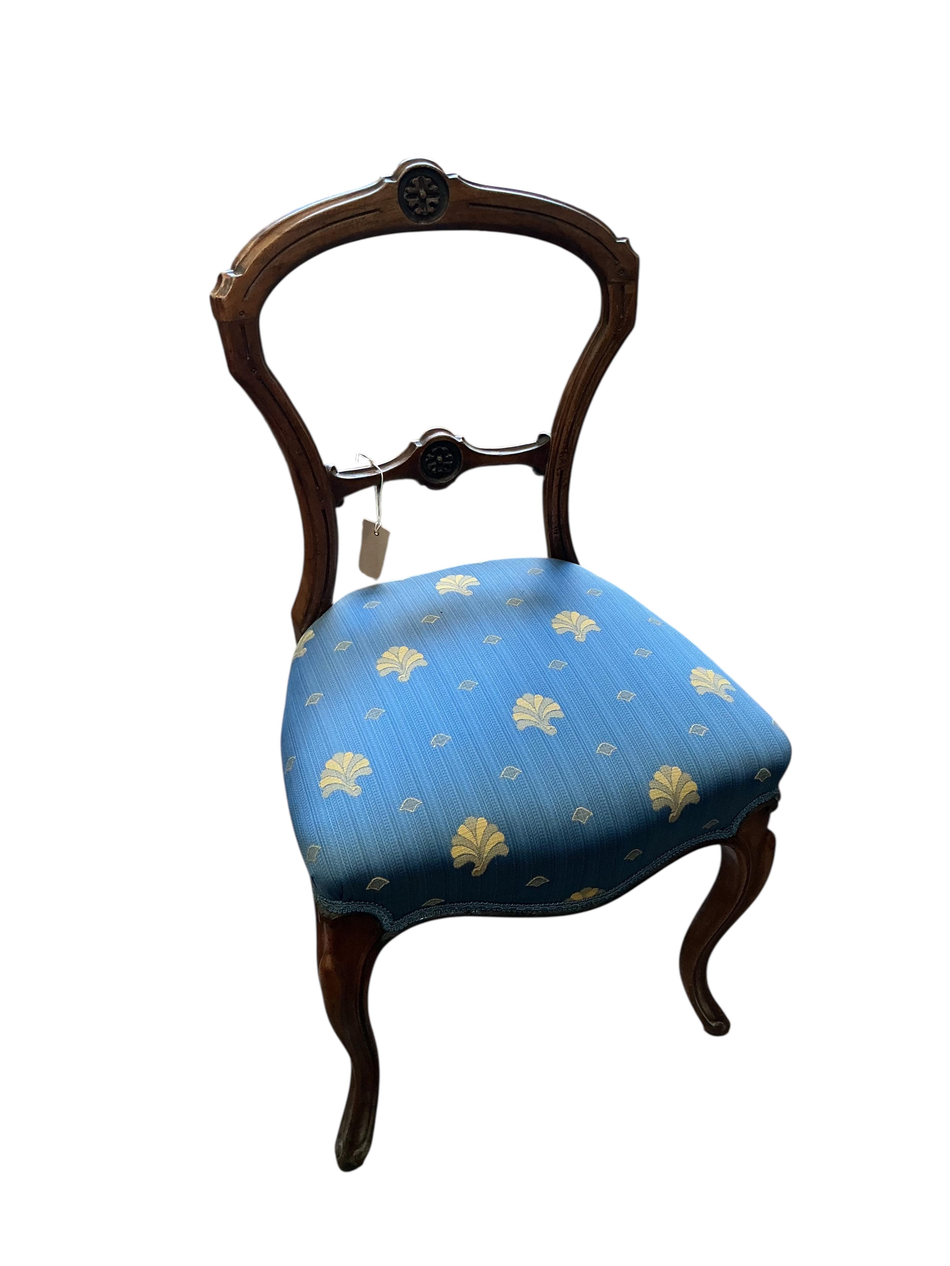 A set of six Victorian walnut balloon back dining chairs